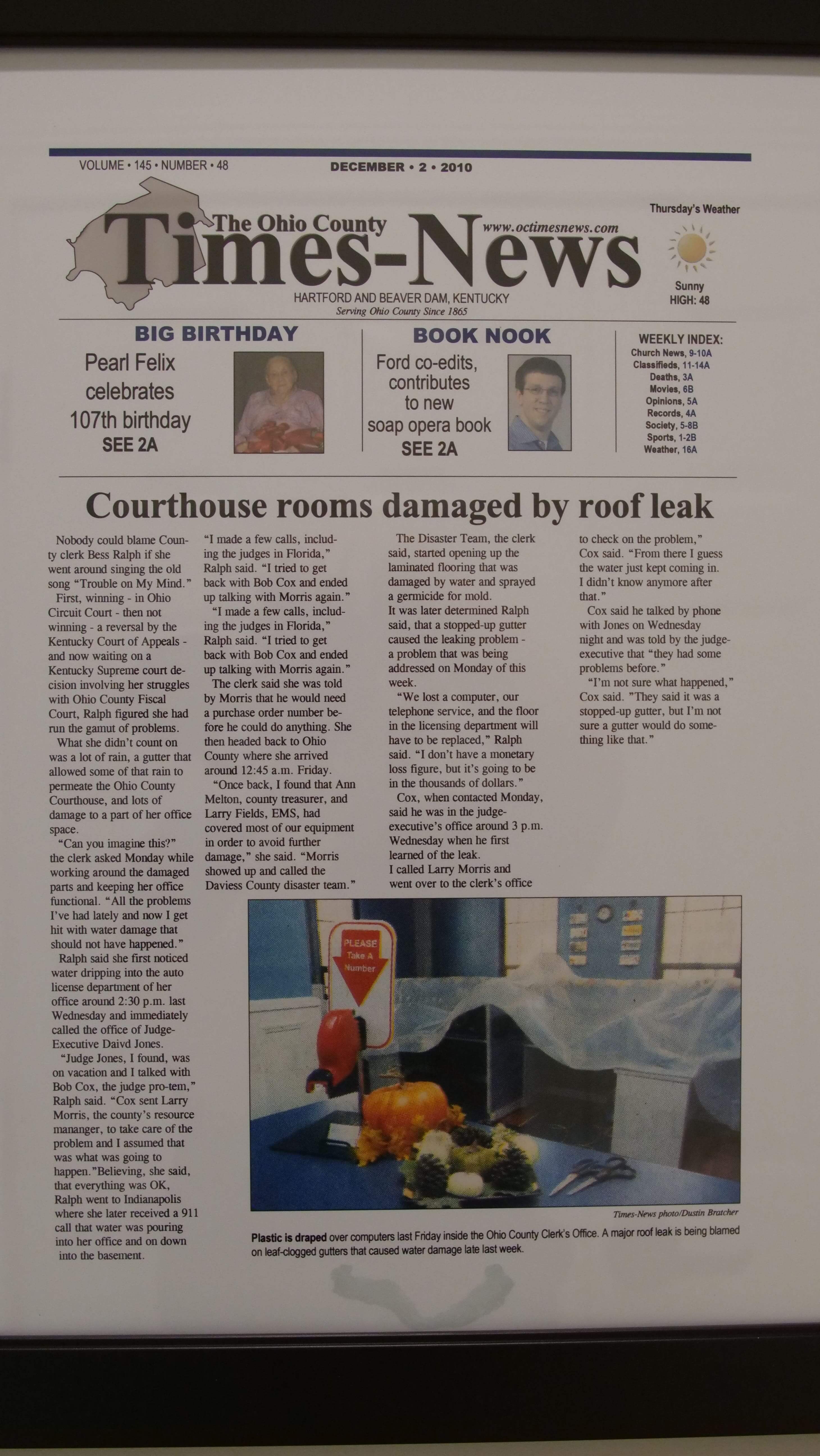 Newspaper showing courthouse rooms being damaged by roof leak